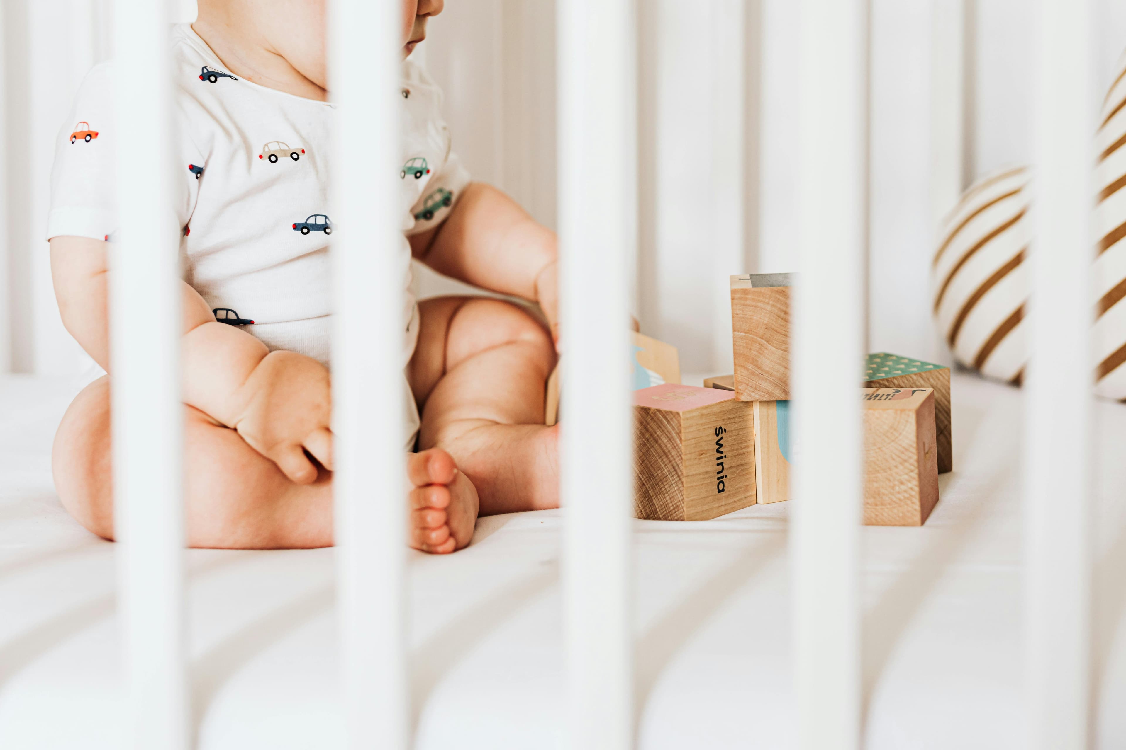 baby in crib playing
