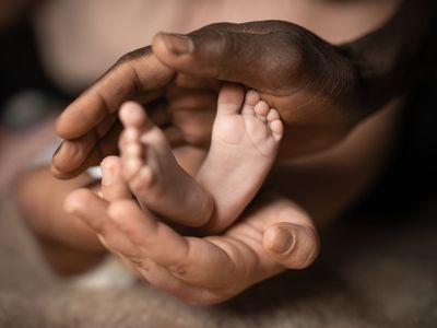 Parents Holding Baby's Feet