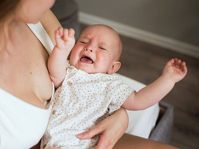 Baby crying in mothers lap