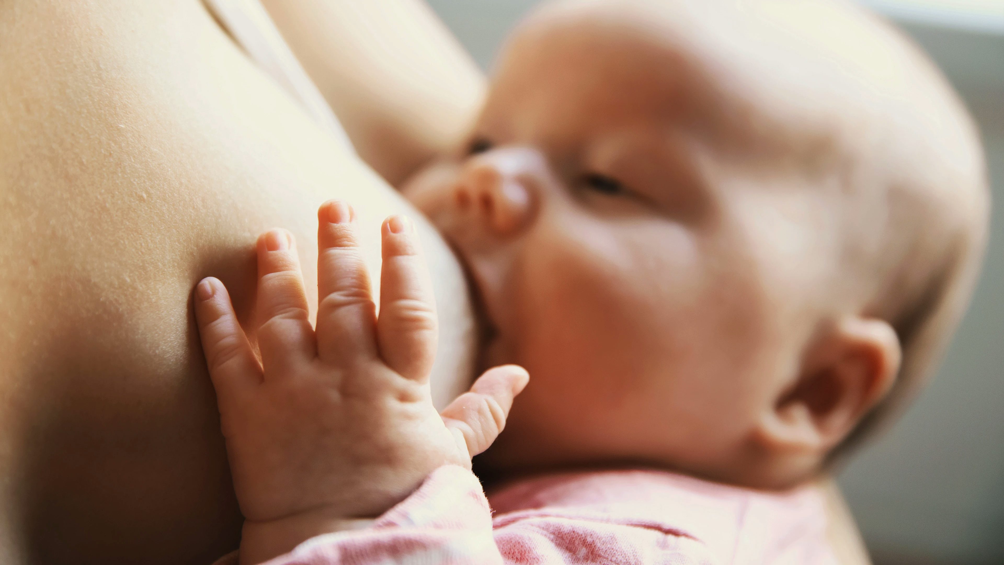 Baby in  mothers arms cluster feeding