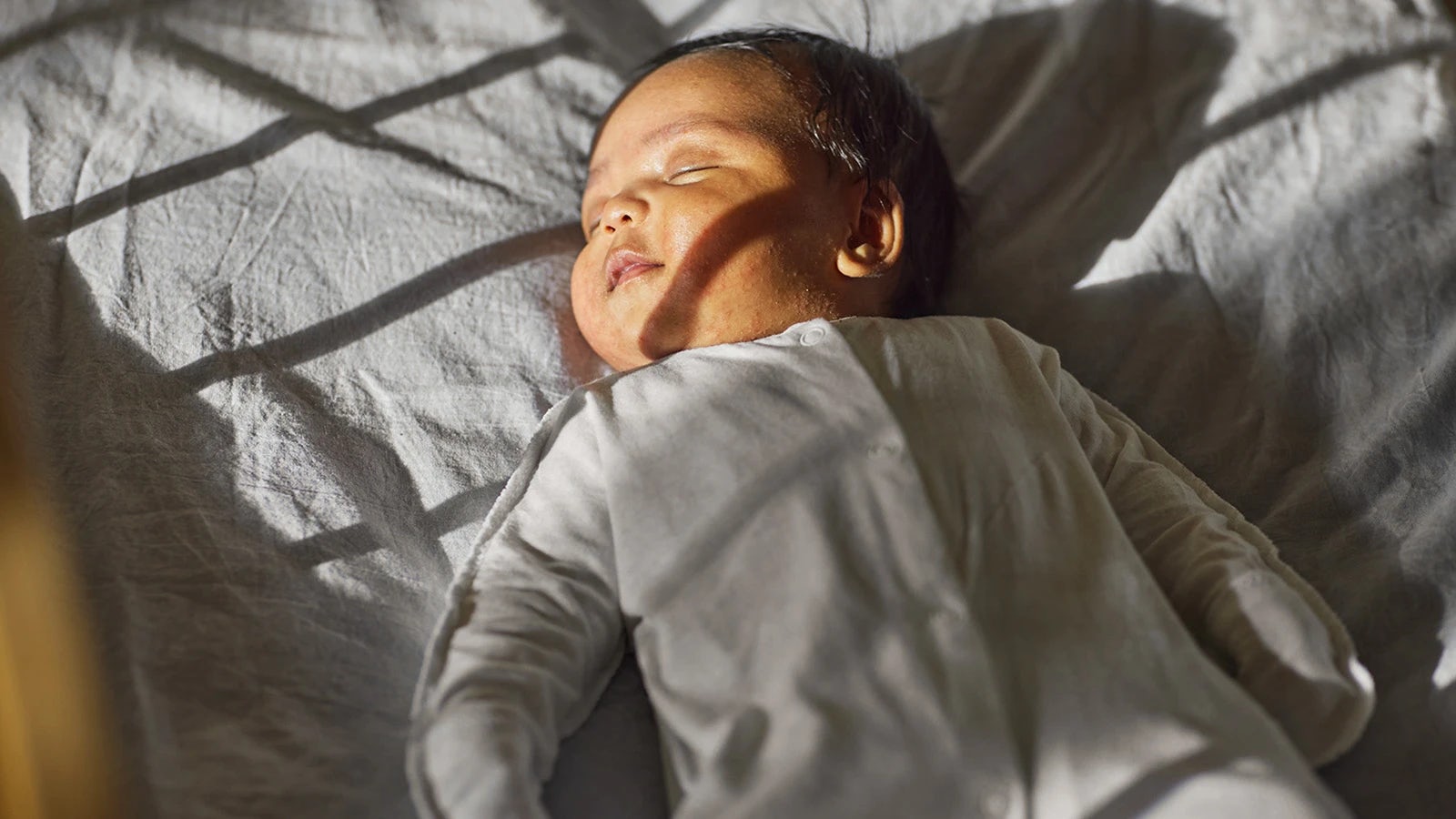 Baby sleeping in a white pyjamas